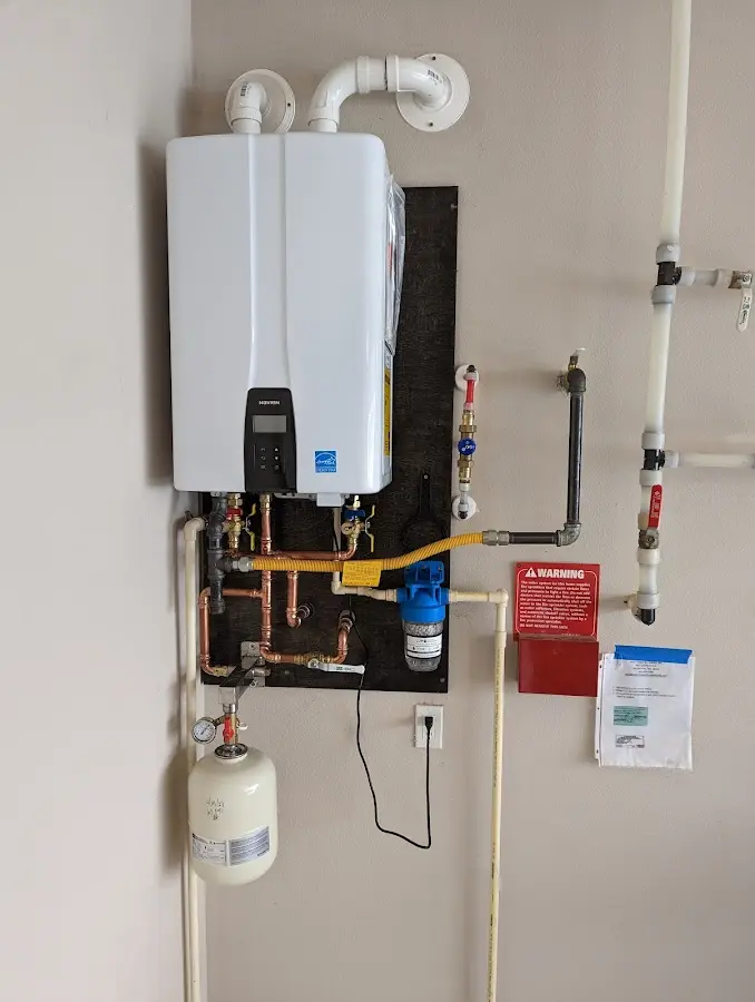 Professional plumber installing copper piping in a St. Johns home